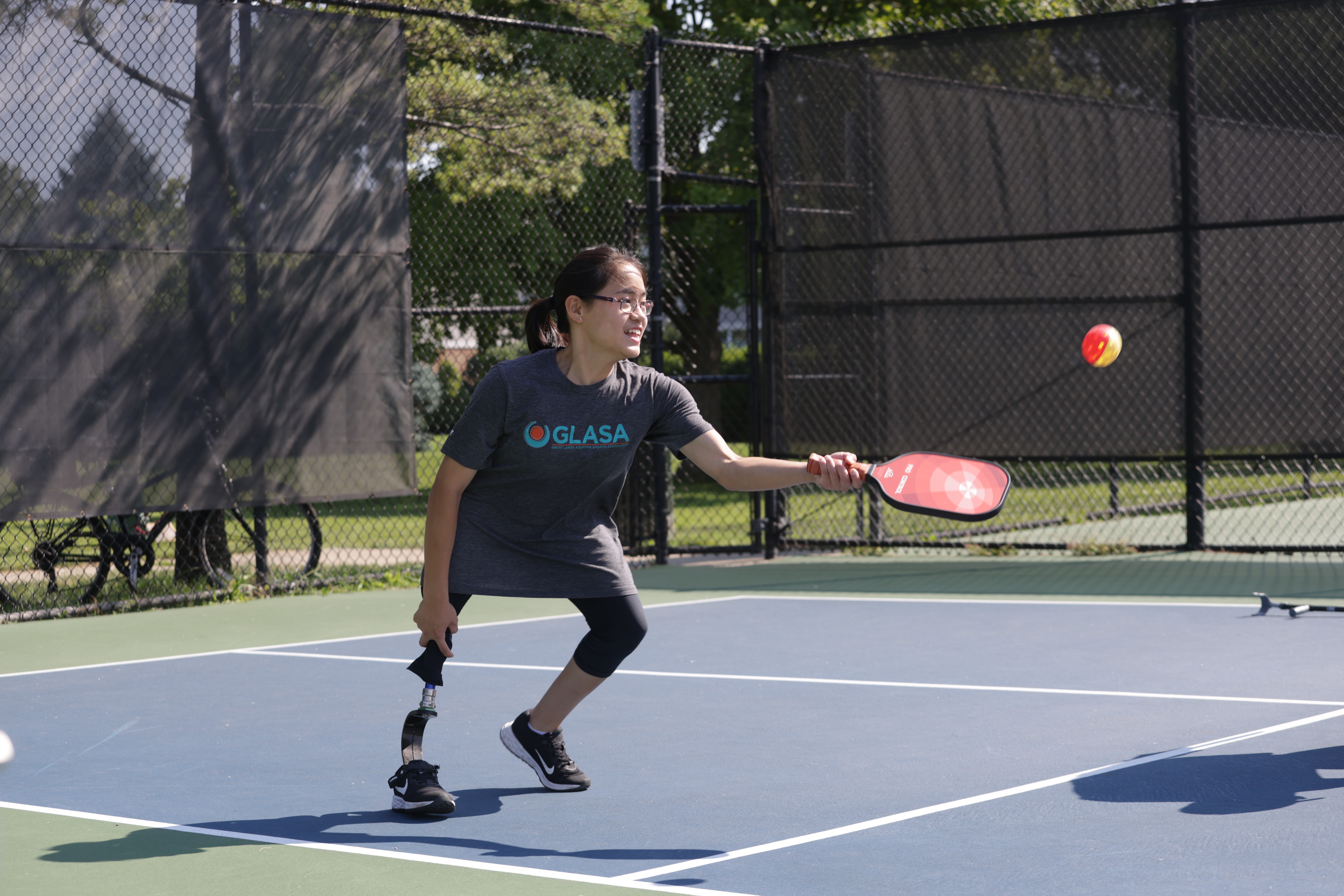 Girl with prosthetic leg playing Pickleball.